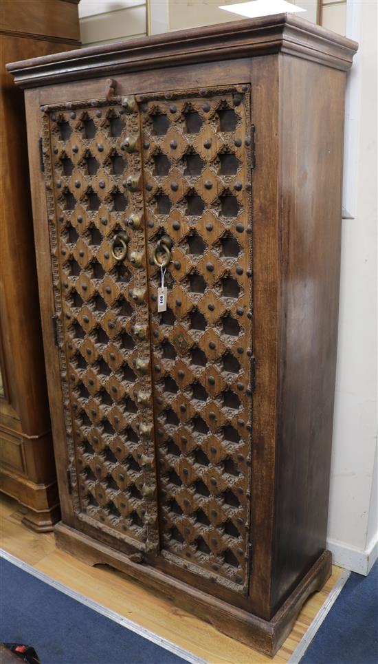 An Indian carved hardwood cupboard W.99cm